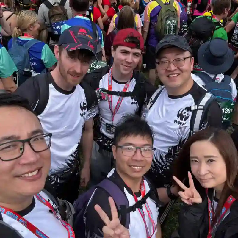 Group of people posing for a selfie at an event, wearing matching outfits with WWF logos.