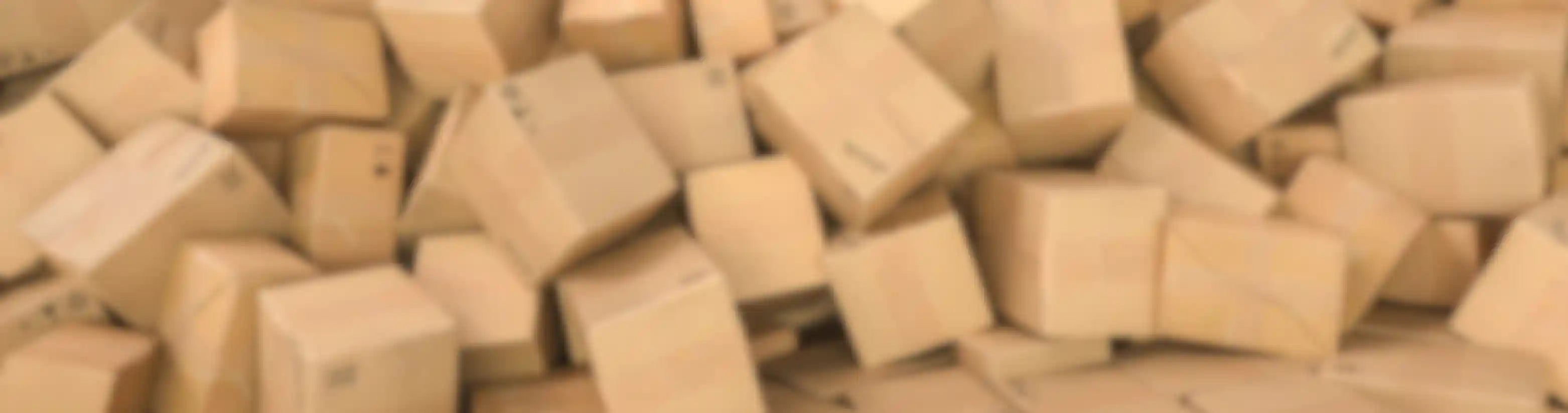 Blurred cardboard boxes in a pile across