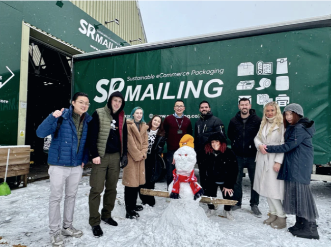 The team with our delivery truck and a snowman.