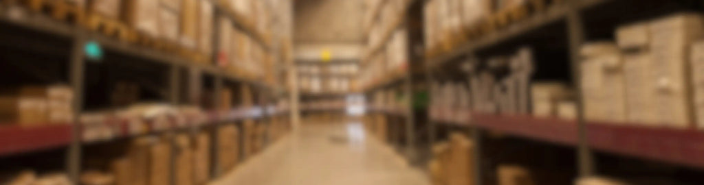 Blurred warehouse interior with shelves and boxes